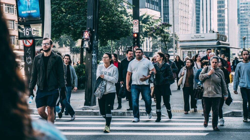 People from all walks of life walking together at an intersection