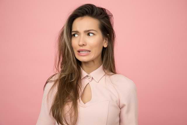 Lady with long hair cringing