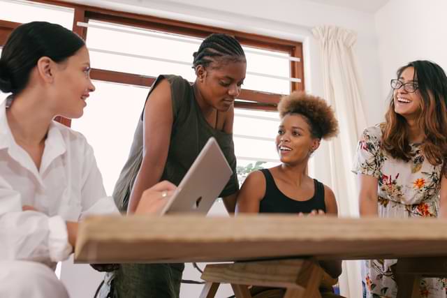 Happy young collaborative women
