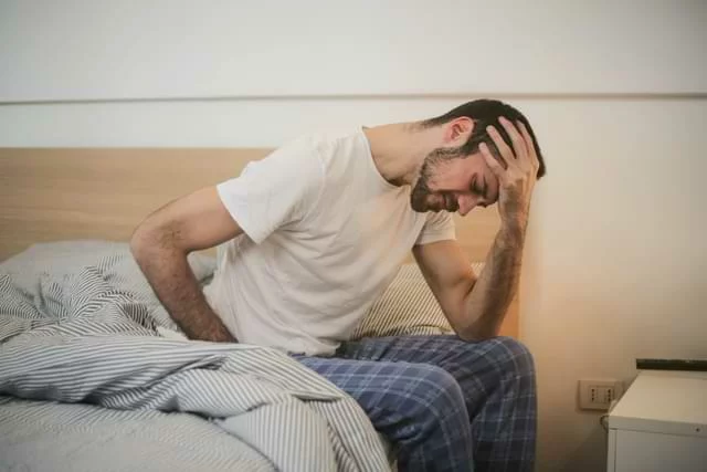 Man Leaning Over Not Sleeping